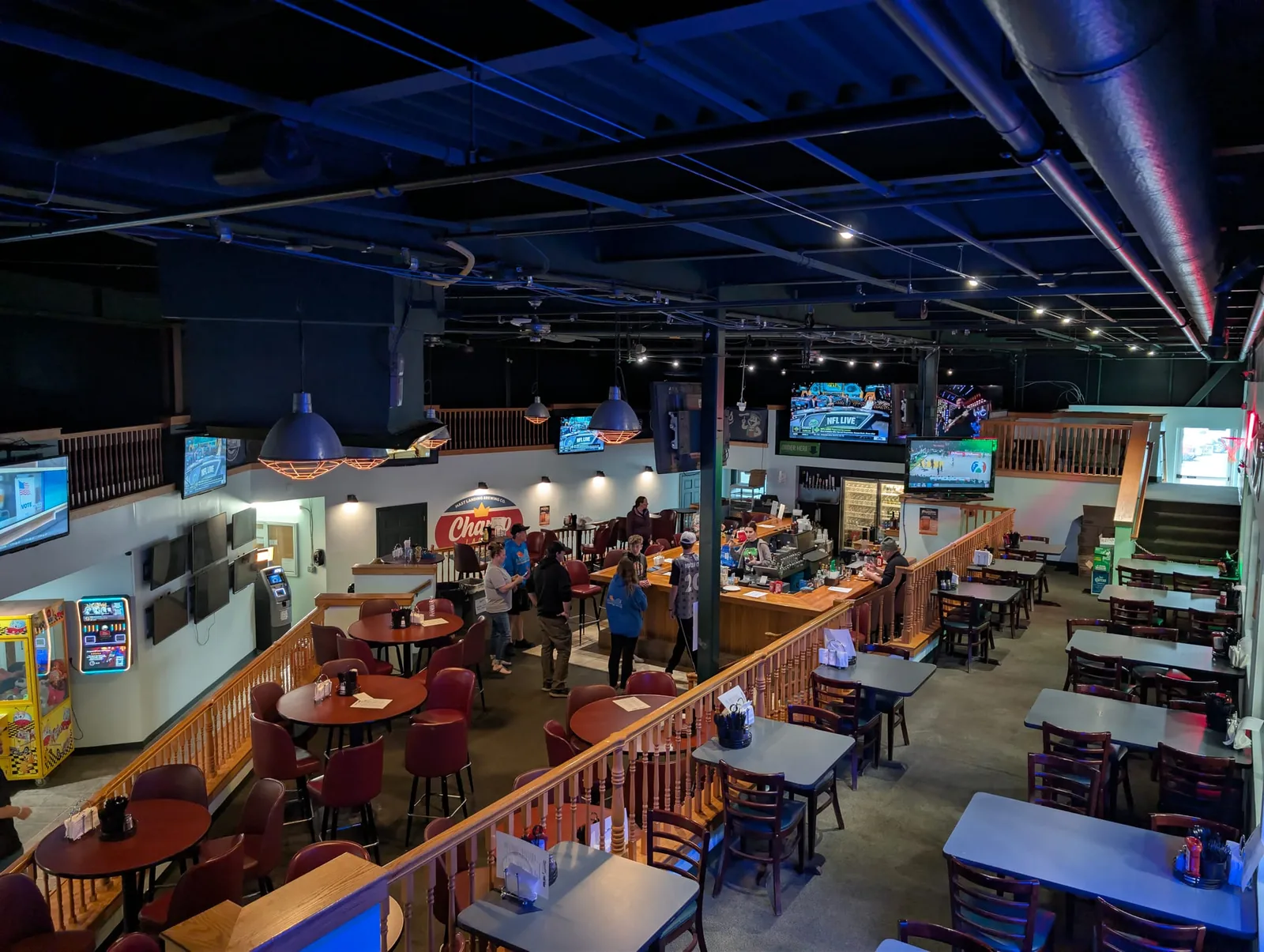Overhead view of the dining floor, mezzanine, and bar with TVs