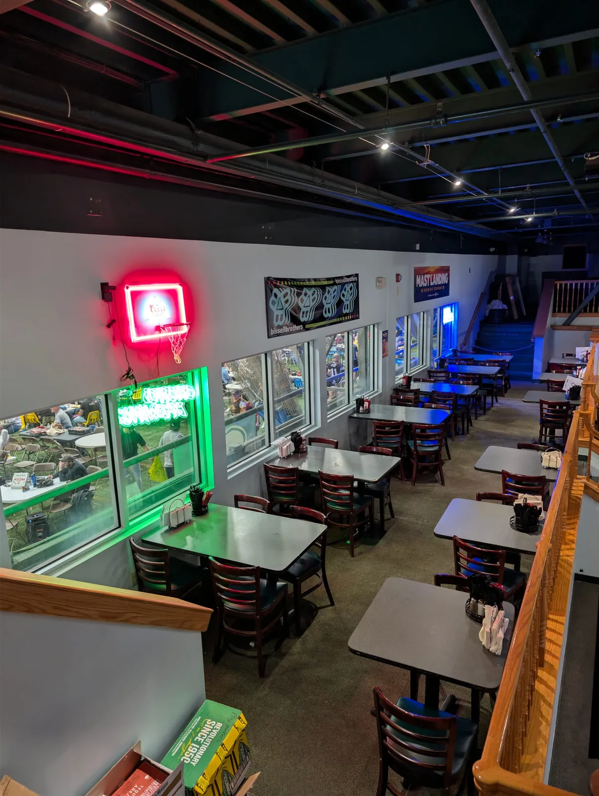 Window-side seating with a red basketball-hoop neon sign